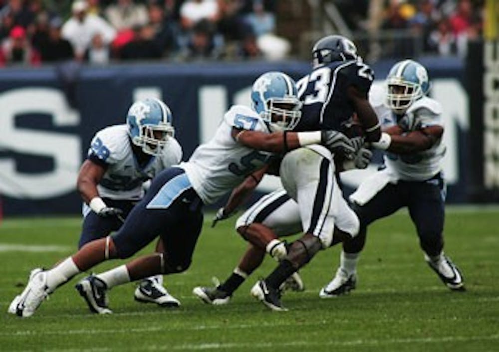 Dion Guy (57) tackles UConn’s Jordan Todman in UNC’s 12-10 victory against the Huskies. 