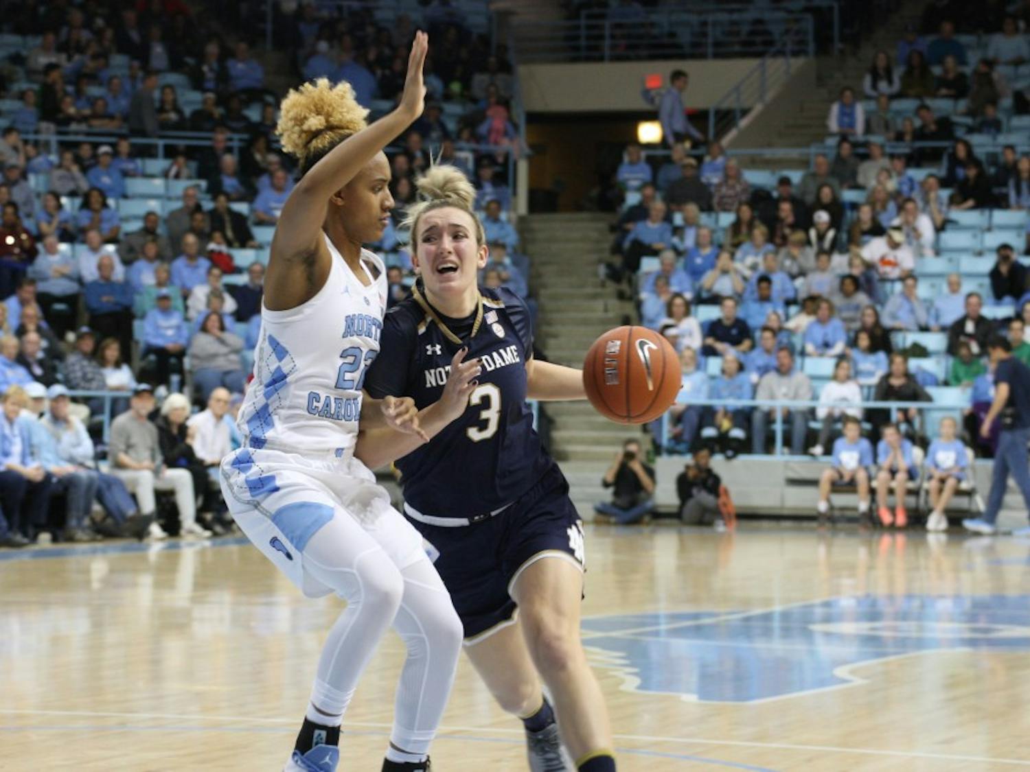 Redshirt senior guard Paris Kea (22) protects the rim against Notre Dame senior guard Marina Mabrey (3) in a UNC upset in Carmichael Arena on Jan. 27, 2019. Kea finished the game with 30 points, 10 assists and 3 rebounds. UNC wins 78-73.