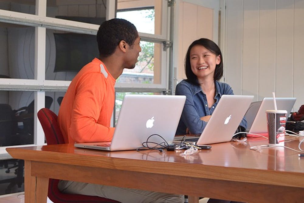 	Nicholas Thomas, founder of Filmlab, and Leeann Chen, a marketing intern, discuss ideas for promotional content for other businesses in the Chapel Hill area.