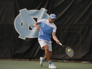 First-year Brian Cernoch, undeclared major, prepares to hit the tennis ball as he plays for the UNC men's tennis team against Duke on Thursday, Feb. 28, 2019 at the Cone-Kenfield Center. UNC won 4-1. Cernoch won his singles match.
