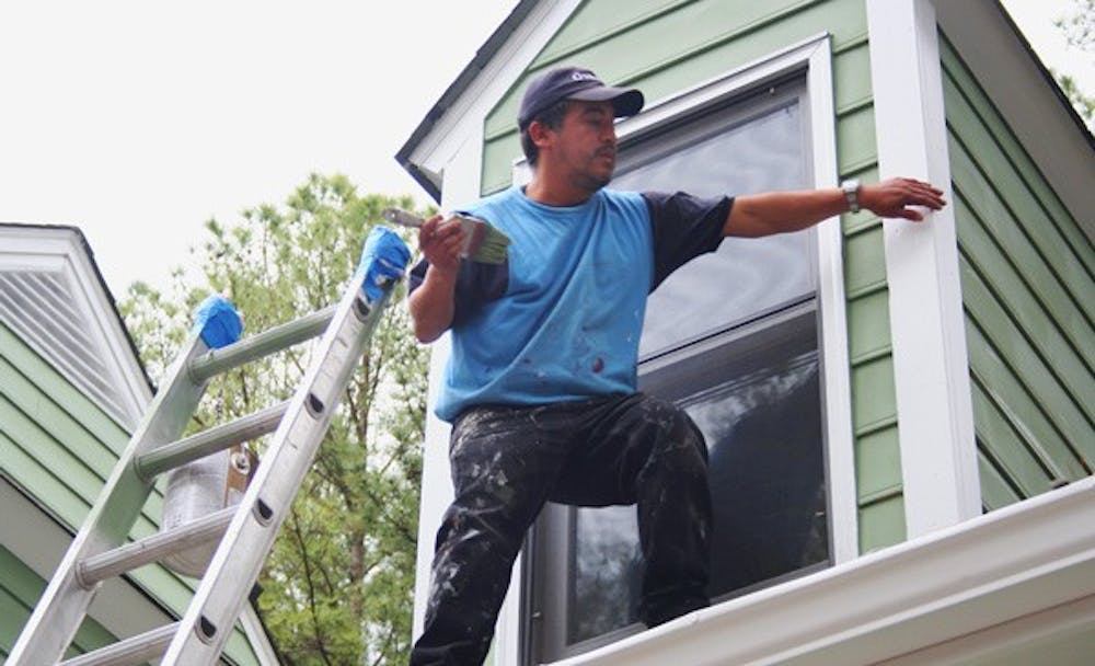 Efren Cisneros, a day laborer from Mexico, puts finishing touches on a Chapel Hill house. DTH/Sam Ward