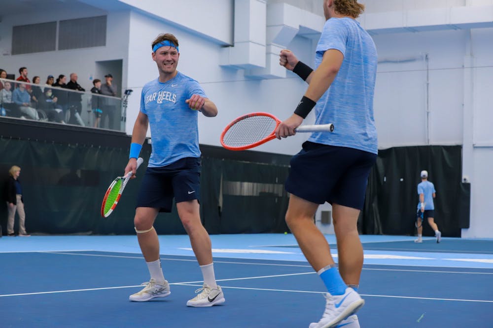 UNC sophomore Casey Kania and graduate Ryan Seggerman celebrate during their match against Harvard on Sunday, January 29, 2023, at the Cone-Kenfield Tennis Center. Kania and Seggerman won the match 6-4.