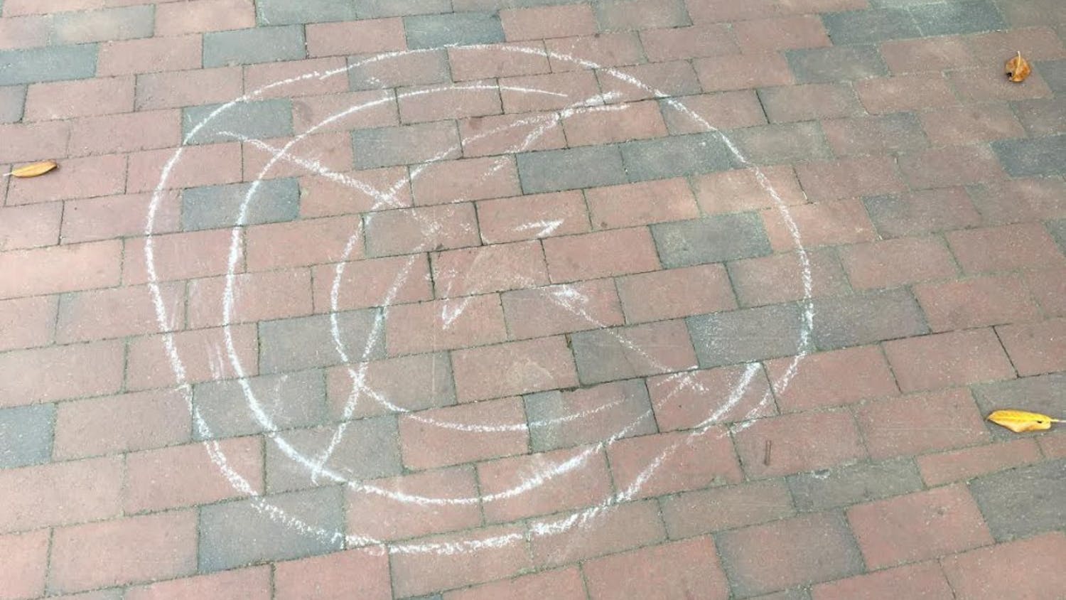 Chalk messages around campus depict the symbol of Islam with an “X” over it.