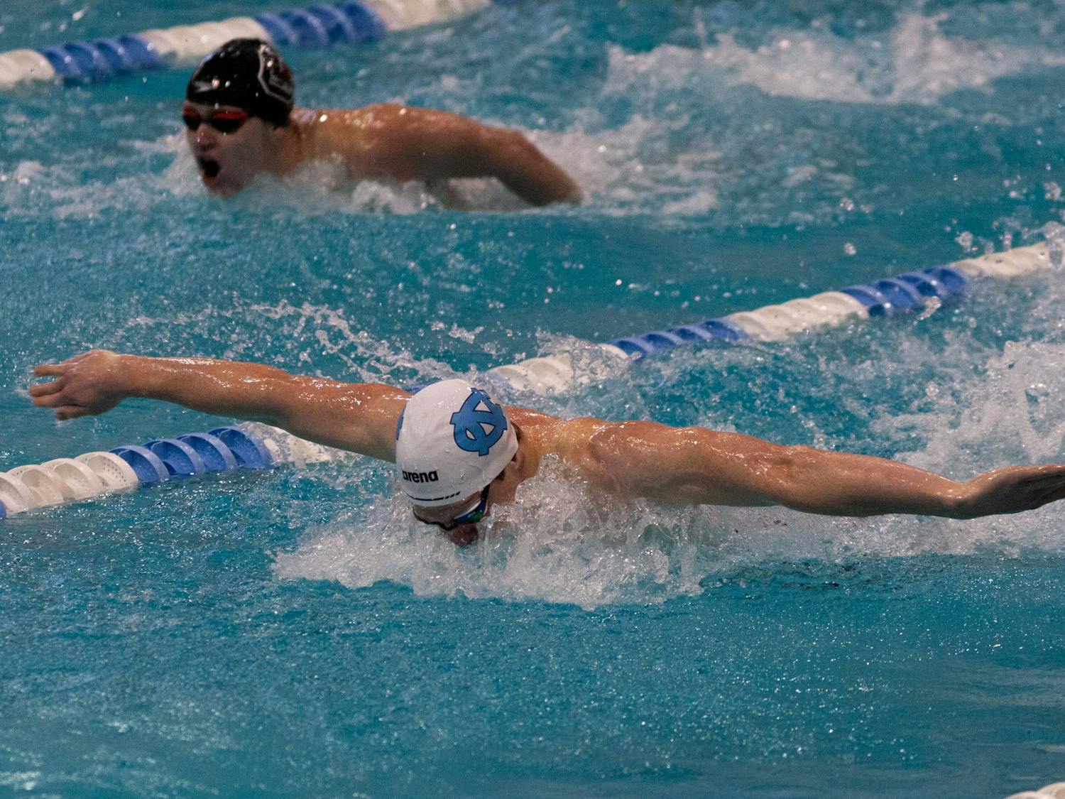 UNC junior fly Boyd Poelke outpaces a South Carolina swimmer in butterfly during the UNC swim and dive meet against South Carolina at Koury Natatorium on Saturday, Nov. 5, 2022. UNC beat South Carolina 179-115 on the men’s side and 178-122 on the women’s side.