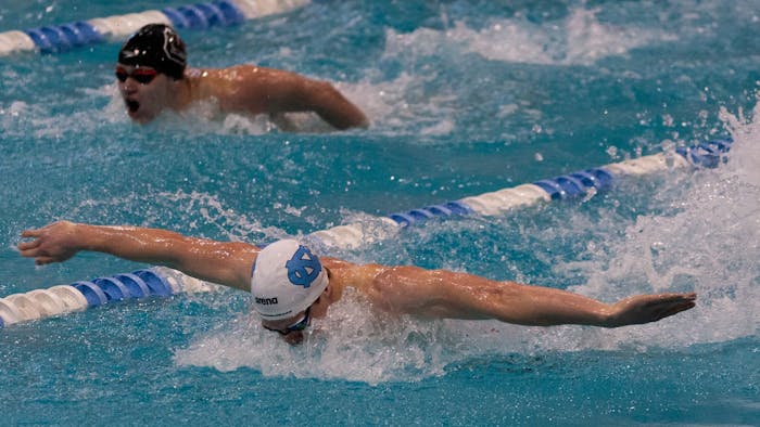 UNC junior fly Boyd Poelke outpaces a South Carolina swimmer in butterfly during the UNC swim and dive meet against South Carolina at Koury Natatorium on Saturday, Nov. 5, 2022. UNC beat South Carolina 179-115 on the men’s side and 178-122 on the women’s side.