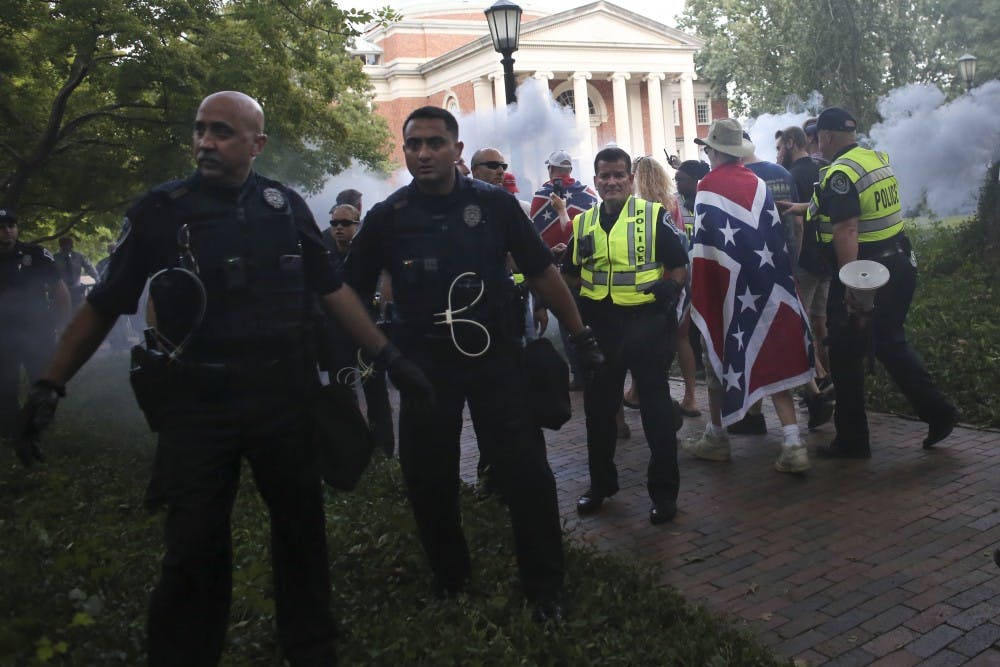 <p>Police from across North Carolina quickly escort demonstrators from McCorkle Place after their scheduled demonstration on Saturday, September 8th.</p>
