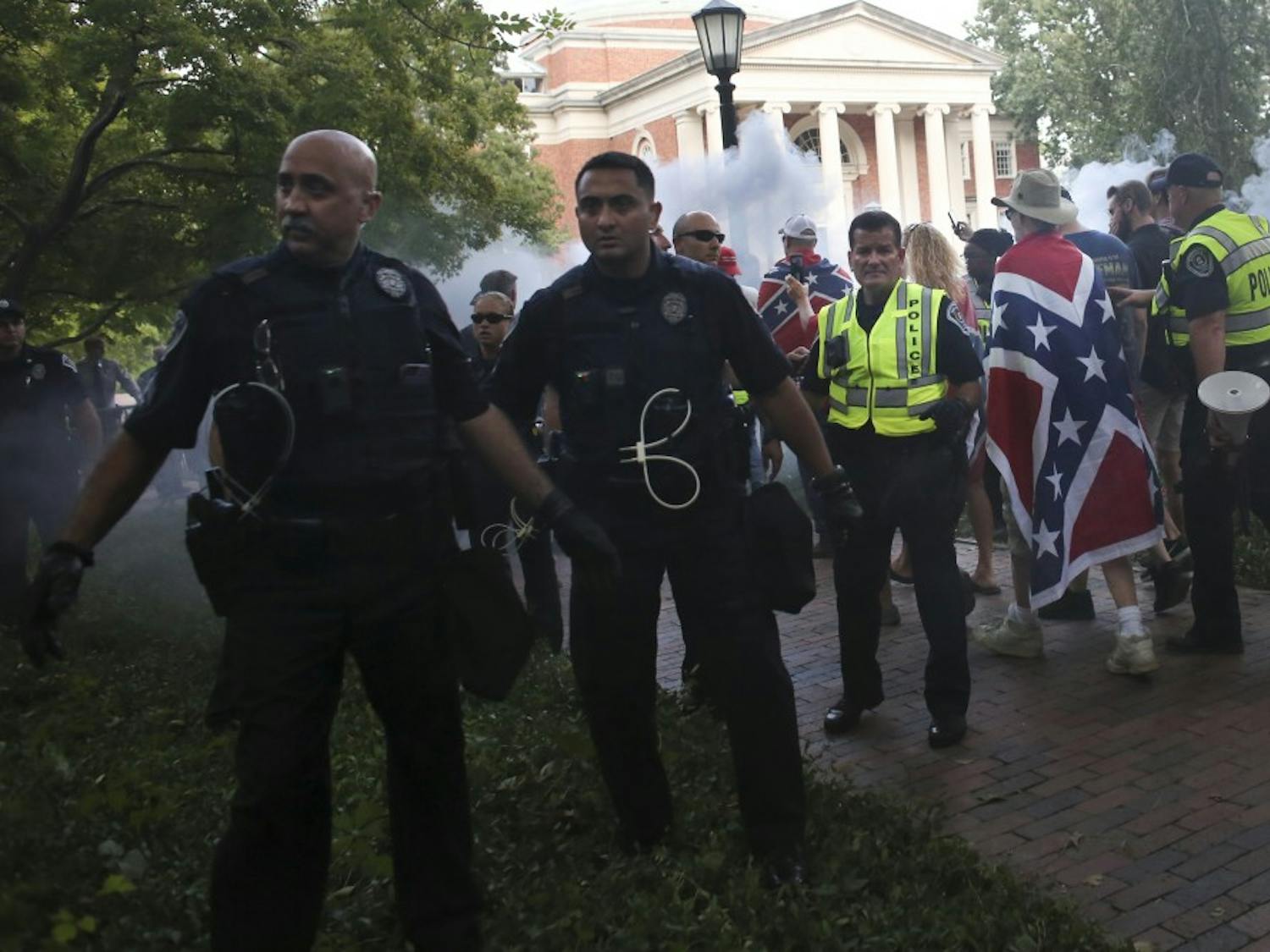 Police from across North Carolina quickly escort demonstrators from McCorkle Place after their scheduled demonstration on Saturday, September 8th.