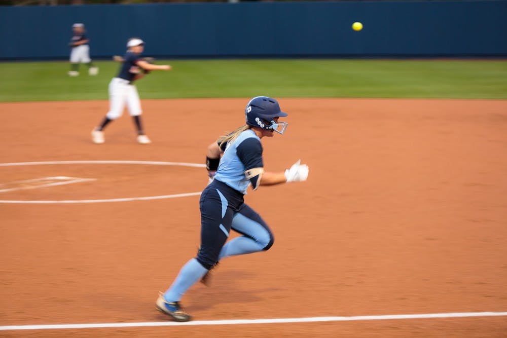 Shortstop Taylor Wike (#7) tries in vain to outrace the ball to first base.
