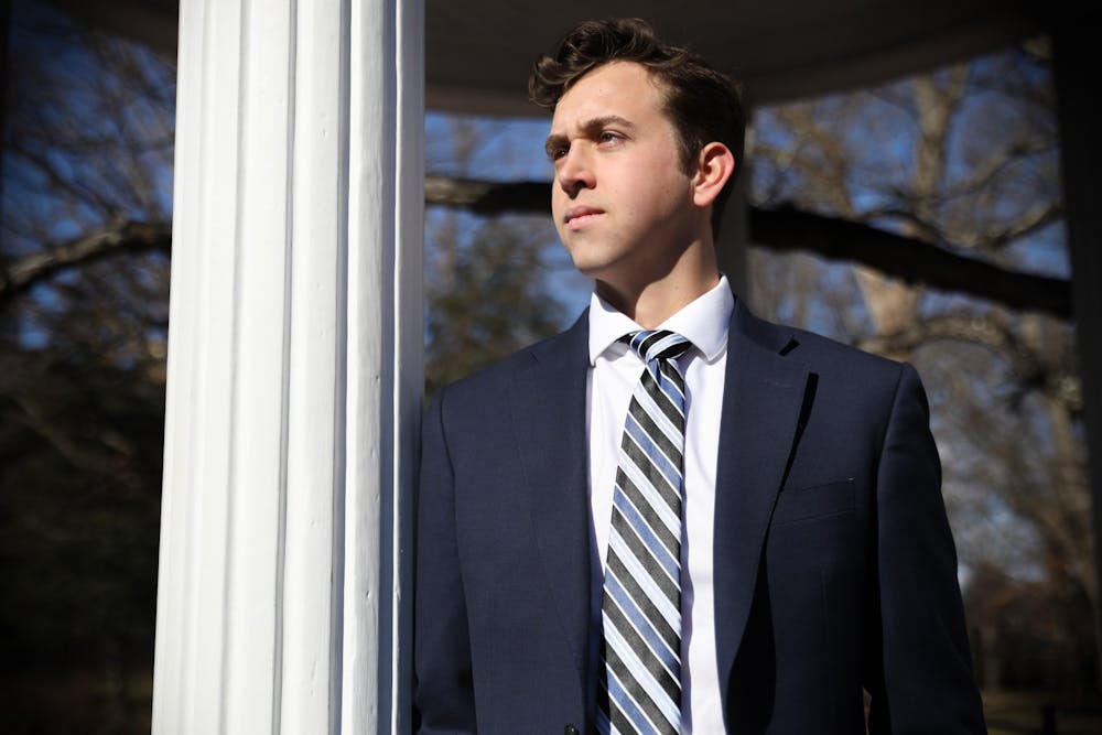 Ethan Phillips, a candidate for student body president, stands by the Old Well on Saturday, Feb. 5, 2022.  