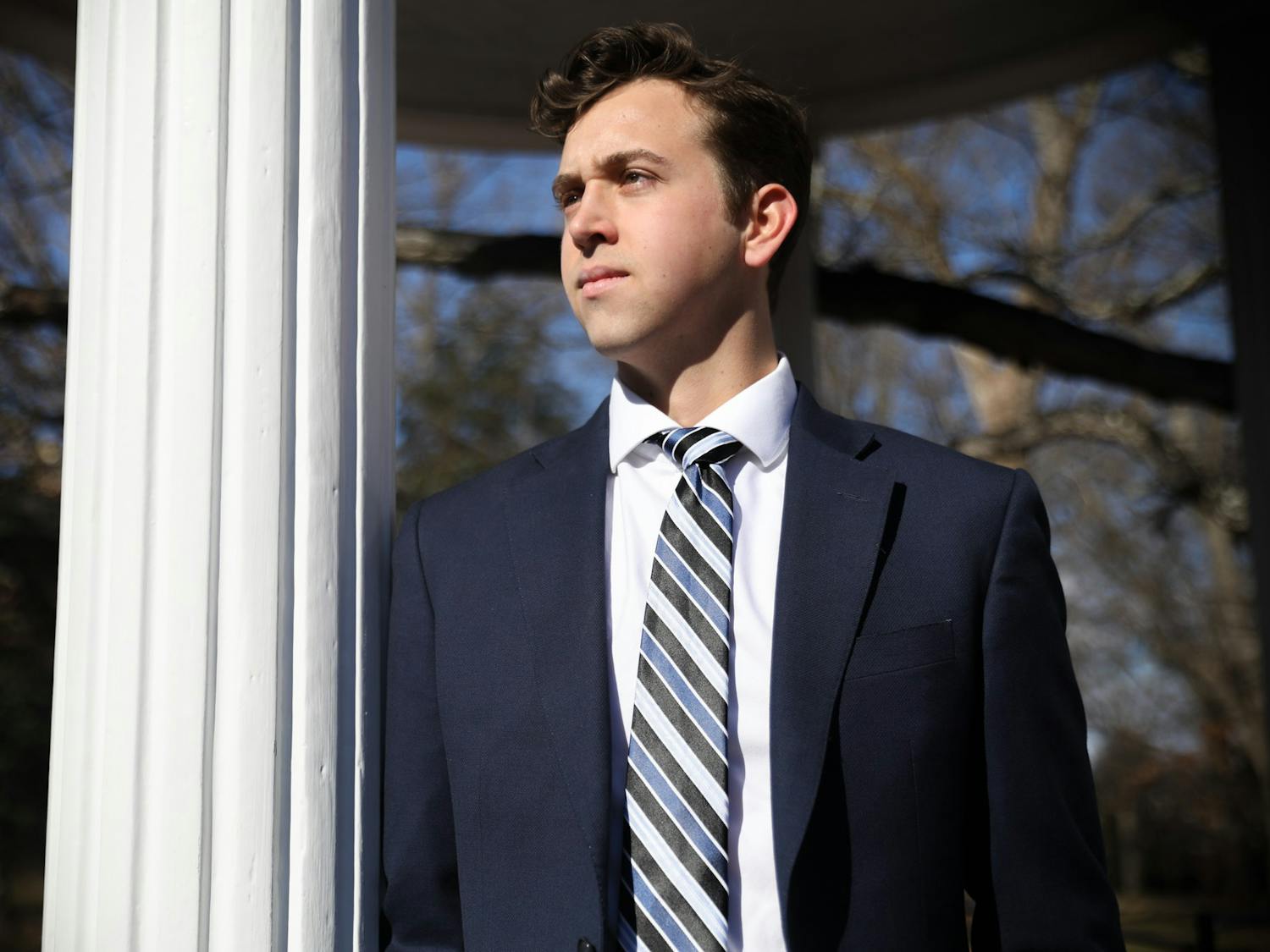 Ethan Phillips, a candidate for student body president, stands by the Old Well on Saturday, Feb. 5, 2022.  