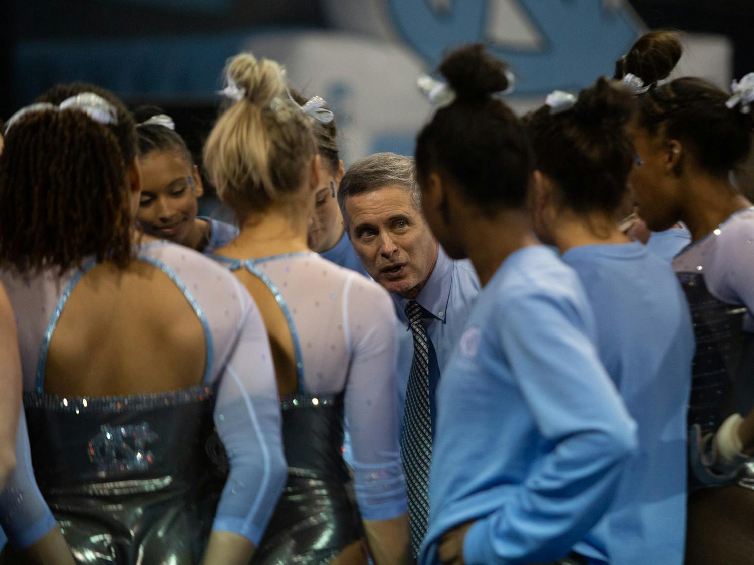 UNC Gymnastics Head Coach Derek Galvin speaks with the team after a meet against University of Pittsburgh on Saturday, Jan. 25, 2020 in Carmichael Arena.