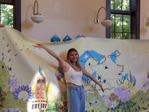 Tam Le, a current junior at UNC, poses in front of her mural for the Campus Y on Thursday, September 1, 2022. The purpose of the mural, as described by the Campus Y's First Year Council, is to "remind students of the beauty in our surroundings, and the light within ourselves and others."