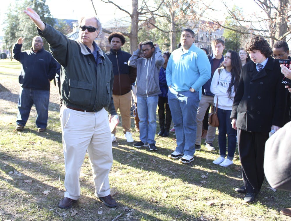 Lecturer in African American studies Frank Porter gives a tour of the African American history of UNC on Friday afternoon. 