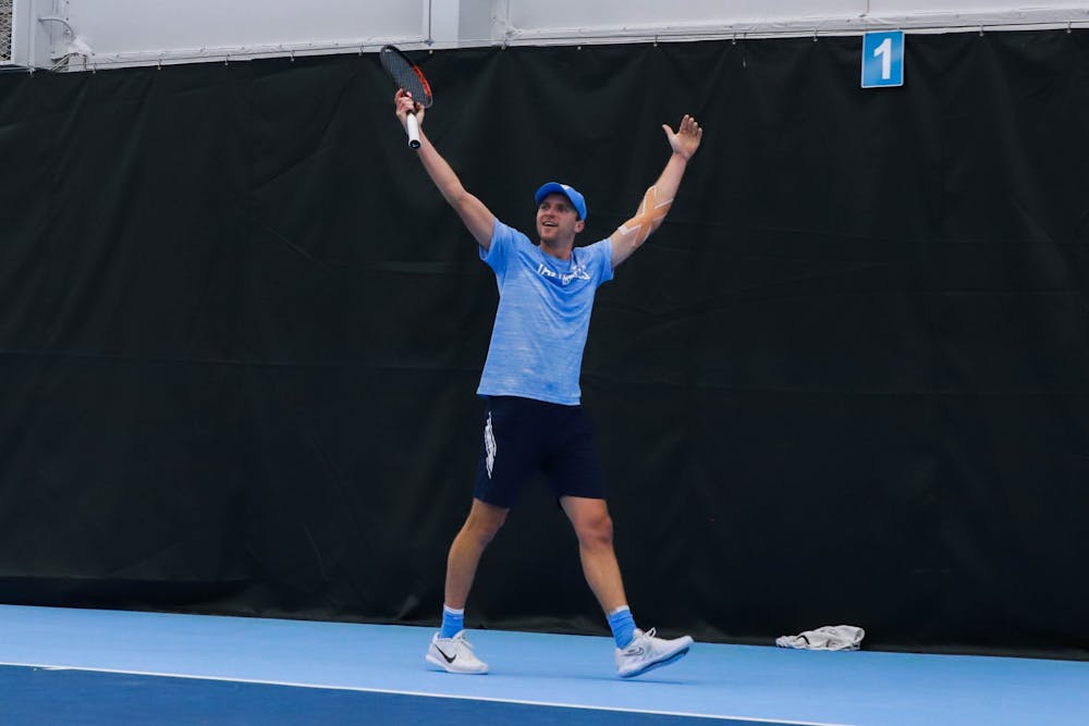 <p>UNC graduate men's tennis player Brian Cernoch celebrates a point against Harvard on Sunday, January 29, 2023, at the Cone-Kenfield Tennis Center. UNC beat Harvard 4-1, winning the team a ticket to Chicago.</p>
