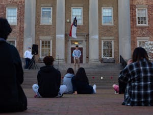 Students and alumni sit together to listen to other members of Chapel HIll community in honor of the 8 lives lost in Atlanta on March 16, 2021. 
