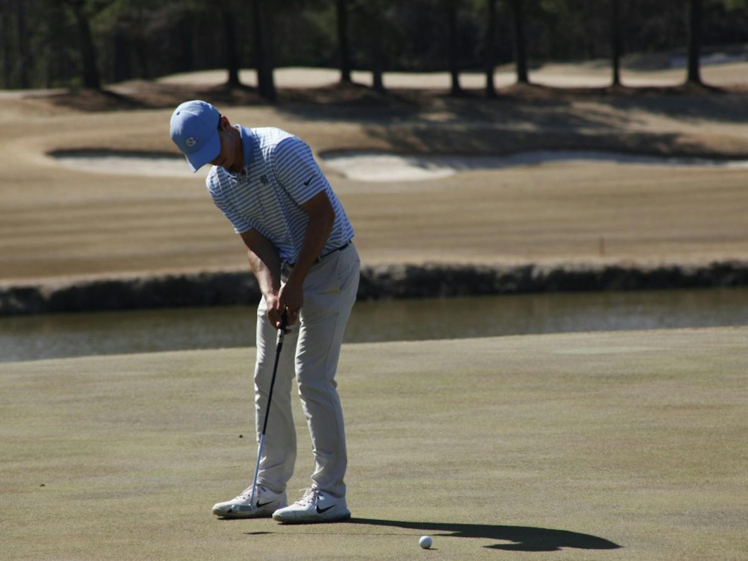First-year Dougie Ergood making a putt during UNC's win at the second day of the Tar Heel Intercollegiate hosted at Finley Golf Course on Sunday, March 24, 2019.
