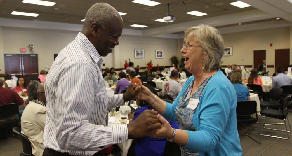 Shirley Massey, Chaplain at the Burn Center, and Larry Stanford, retired Raleigh fire chief and volunteer at the burn center for 20 years, dance along to the Dakata Street Band at the reunion banquet for survivors on Saturday.
