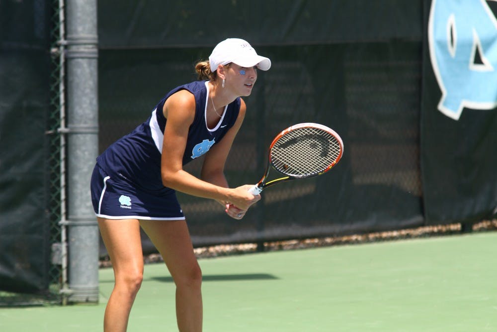 Caroline Price awaits a serve from her singles opponent. 