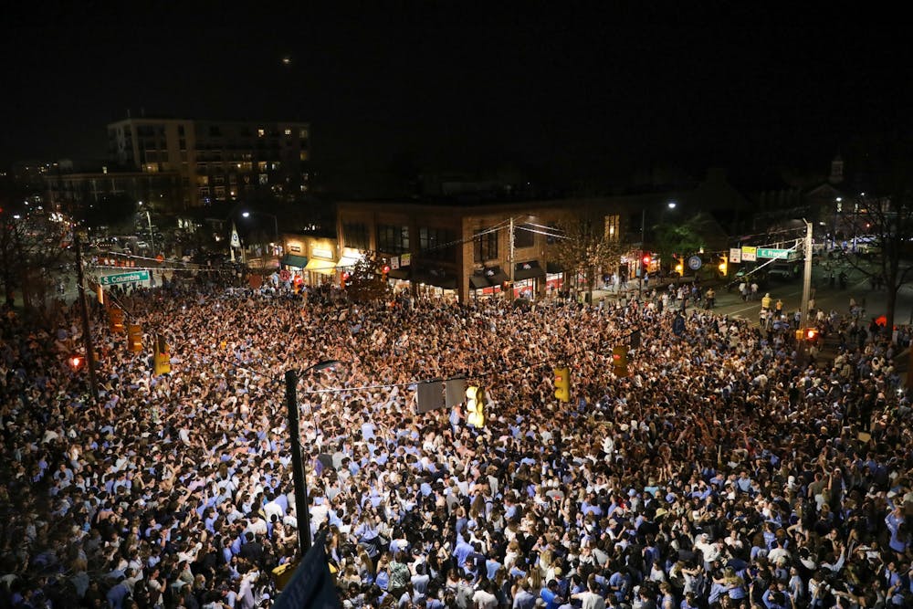 <p>Students and community members rush Franklin Street on Saturday, March 5, 2022, after North Carolina basketball defeated Duke, 94-81.</p>