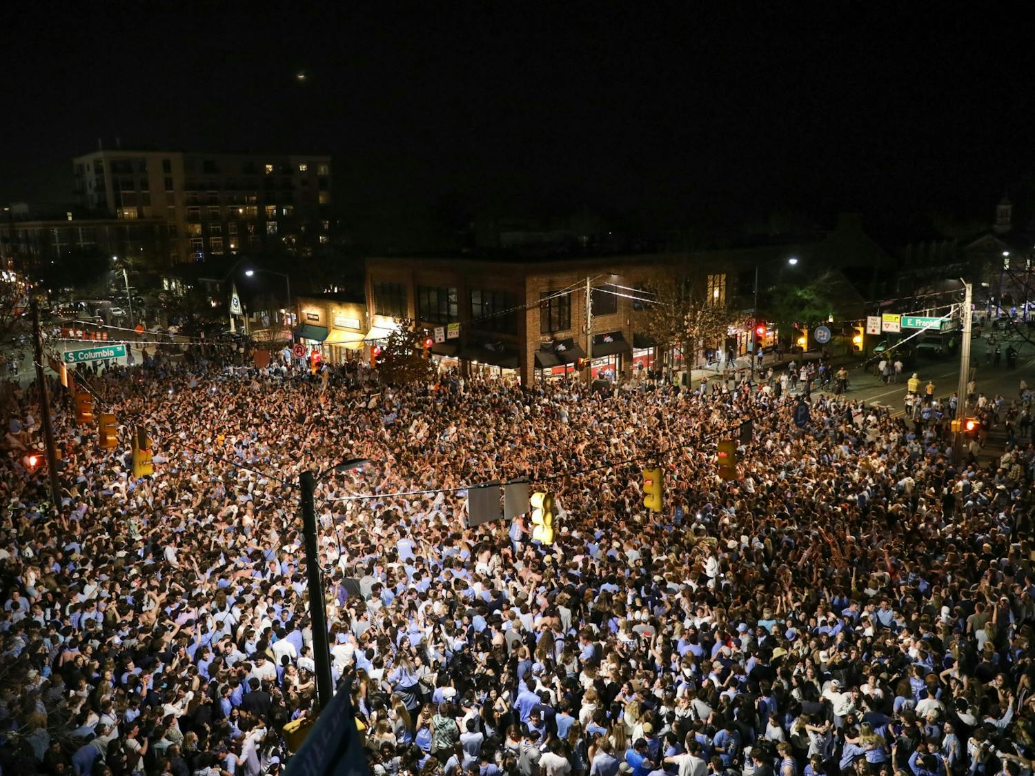 Students and community members rush Franklin Street on Saturday, March 5, 2022, after North Carolina basketball defeated Duke, 94-81.