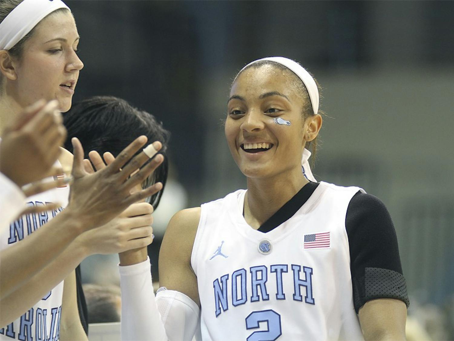 Senior guard Latifah Coleman celebrates with the bench during the tar heel's huge win over Carson-Newman. (88-27)