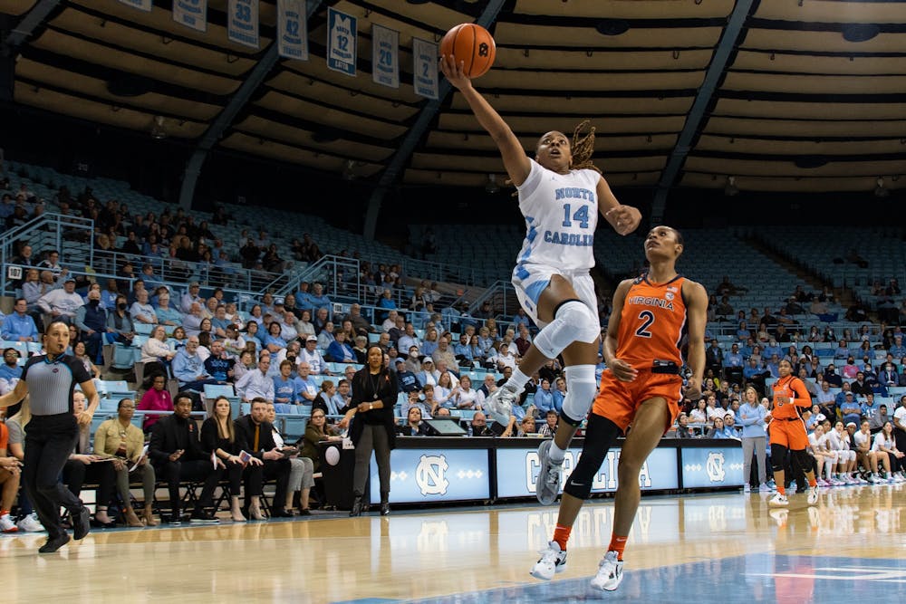 UNC redshirt first year guard Kayla McPherson (14) makes a layup during UNC's game against UVA on Thursday, Feb. 2, 2023.