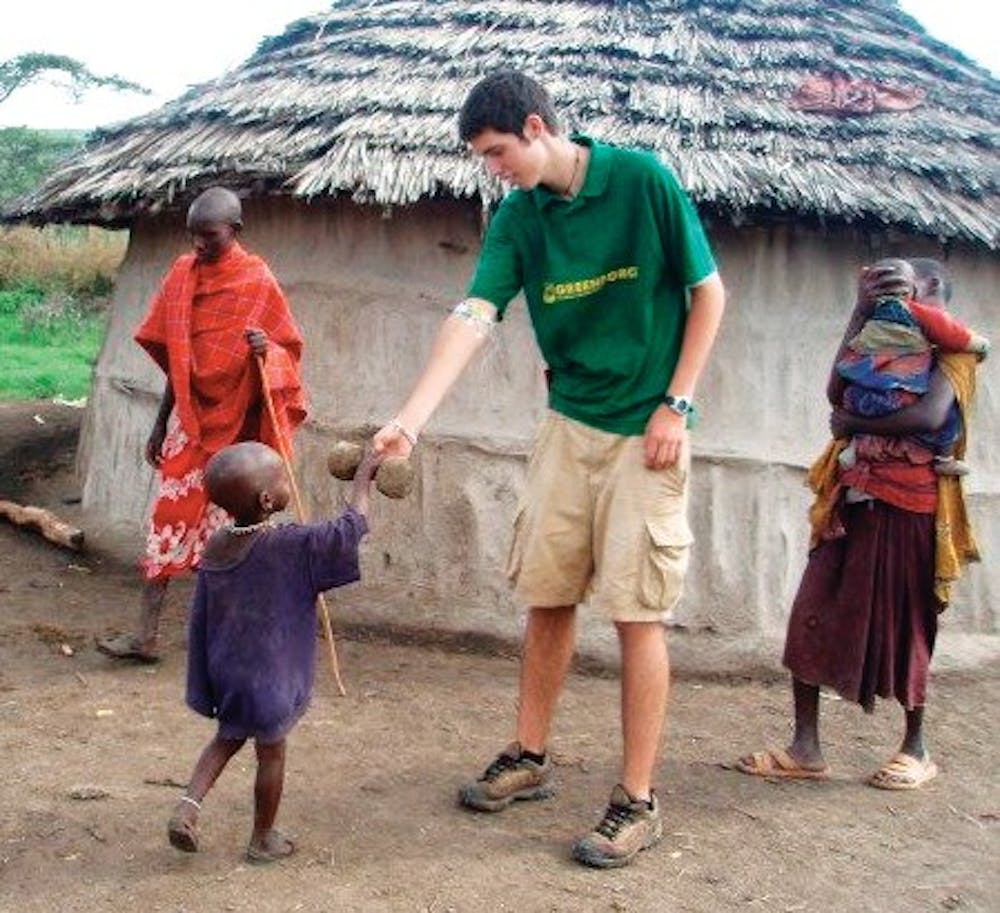 	Conor Farese plays with Tupapa Maasai and his brother Papai, a family he got to know while working in Monduli Juu, Tanzania. While in Tanzania, Farese taught English and helped construct a school in the village. &#8211; Courtesy of Conor Farese