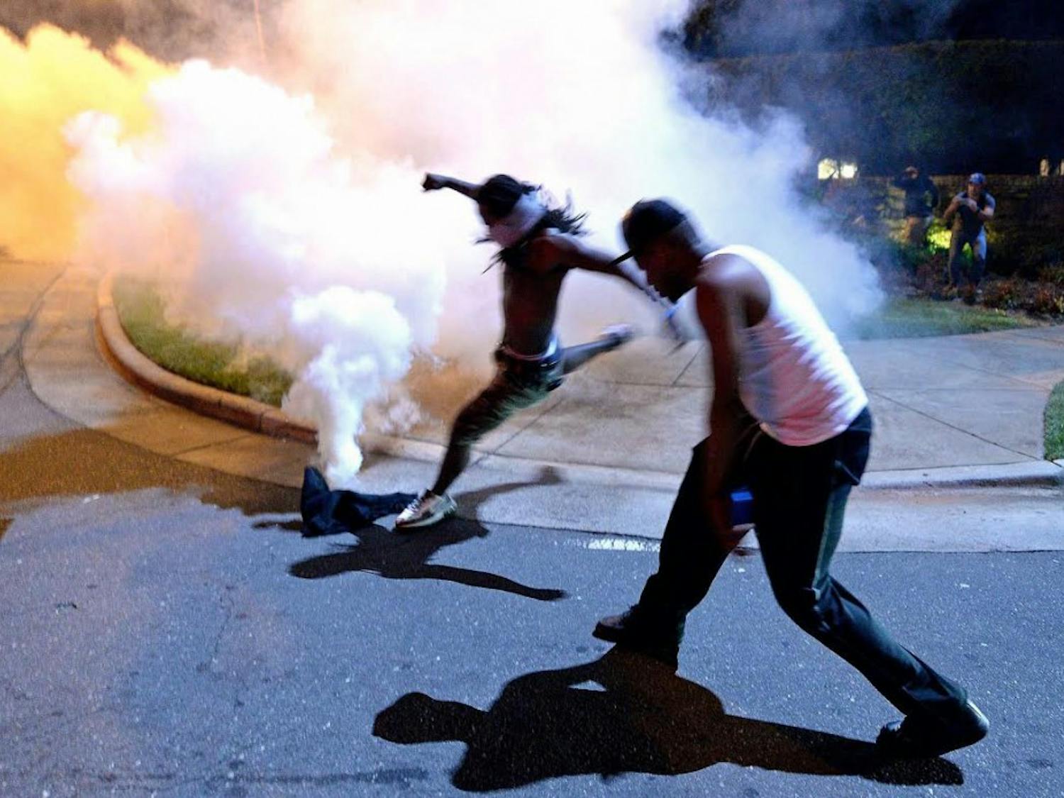 A protestor kicks a tear gas canister fired by Charlotte-Mecklenburg police officers along Old Concord Rd. in Charlotte, NC on Tuesday night. A protest began on Old Concord Road at Bonnie Lane, where a Charlotte-Mecklenburg police officer fatally shot a man in the parking lot of The Village at College Downs apartment complex Tuesday afternoon.The man who died was identified late Tuesday as Keith Scott, 43 and the officer who fired the fatal shot was CMPD Officer Brentley Vinson.