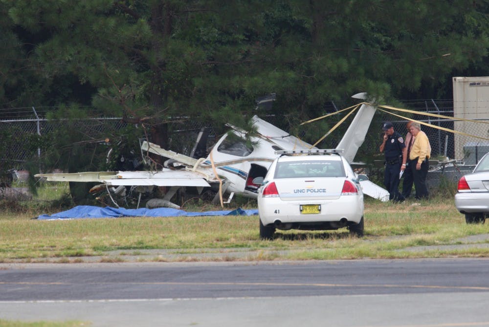 	<p>Police investigate a plane crashed at the Horace Williams airport Monday. </p>