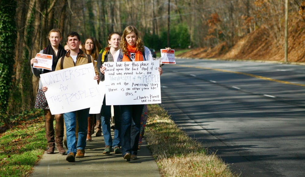 UNC-Chapel Hill students, led by Joseph Terrell (left) and Elizabeth McCain (right), march from the Pit to the Board of Governor's meeting in protest of tuition hikes.  