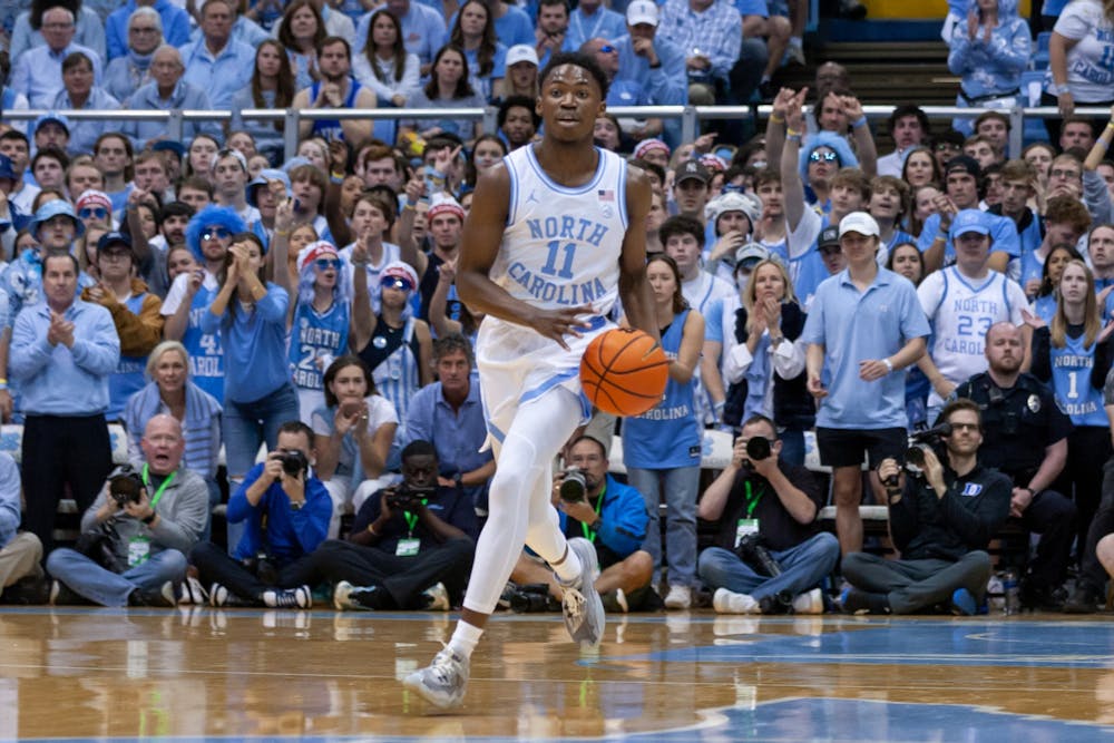 UNC sophomore guard D'Marco Dunn (11) dribbles the ball during the men's basketball game against Duke at the Dean E. Smith Center on Saturday, March 4, 2023. UNC fell to Duke 62-57.