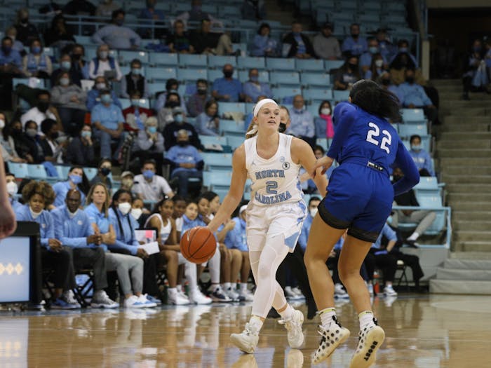 UNC graduate student guard Carlie Littlefield (2) dribbles the ball up the court against a UNC Asheville defender during a home game at Carmichael Arena on Dec. 12.