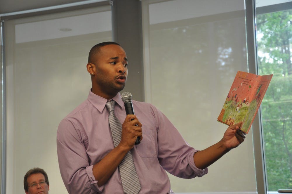 <p>Omar Currie, a former teacher at Efland Cheeks Elementary school, reads from children's book "King and King" at the Chapel Hill Public Library. Currie resigned from the school after a controversy emerged over Currie reading the book, which features a marriage between gay characters, to his third-grade class.</p>