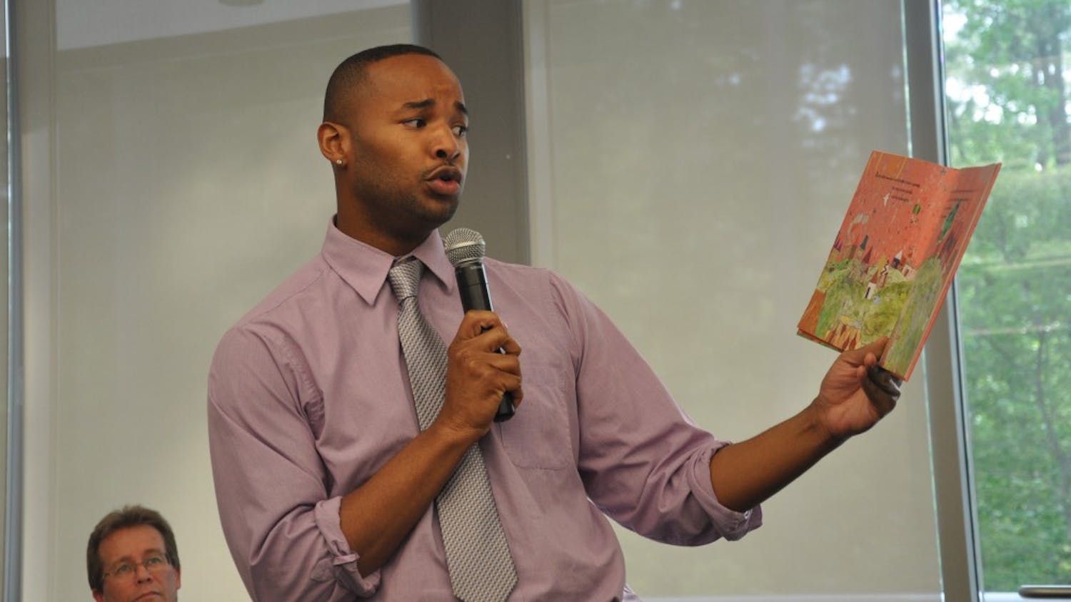 Omar Currie, a former teacher at Efland Cheeks Elementary school, reads from children's book "King and King" at the Chapel Hill Public Library. Currie resigned from the school after a controversy emerged over Currie reading the book, which features a marriage between gay characters, to his third-grade class.