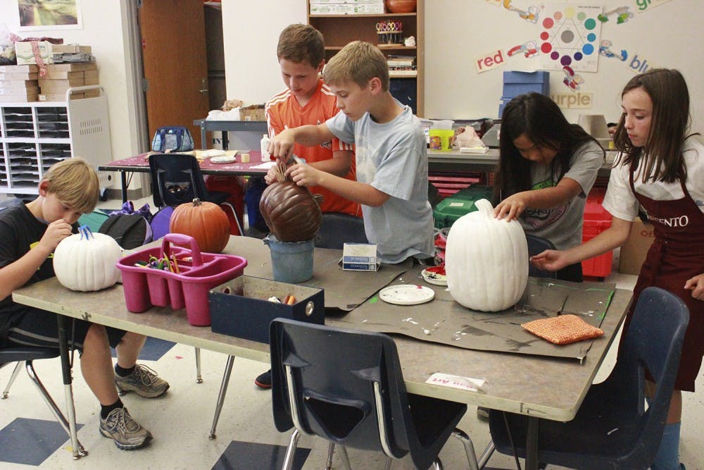 5th grade Art Club students at Morris Grove Elementary painted pumpkins on Tuesday after school for a pumpkin sale that will raise money for United Way. Art Club teacher, Mrs. Becky Springer, said the inspiration for the fundraiser came because "I'm just always looking for a creative outlet for the students...and then it just happened to coincide with United Way."