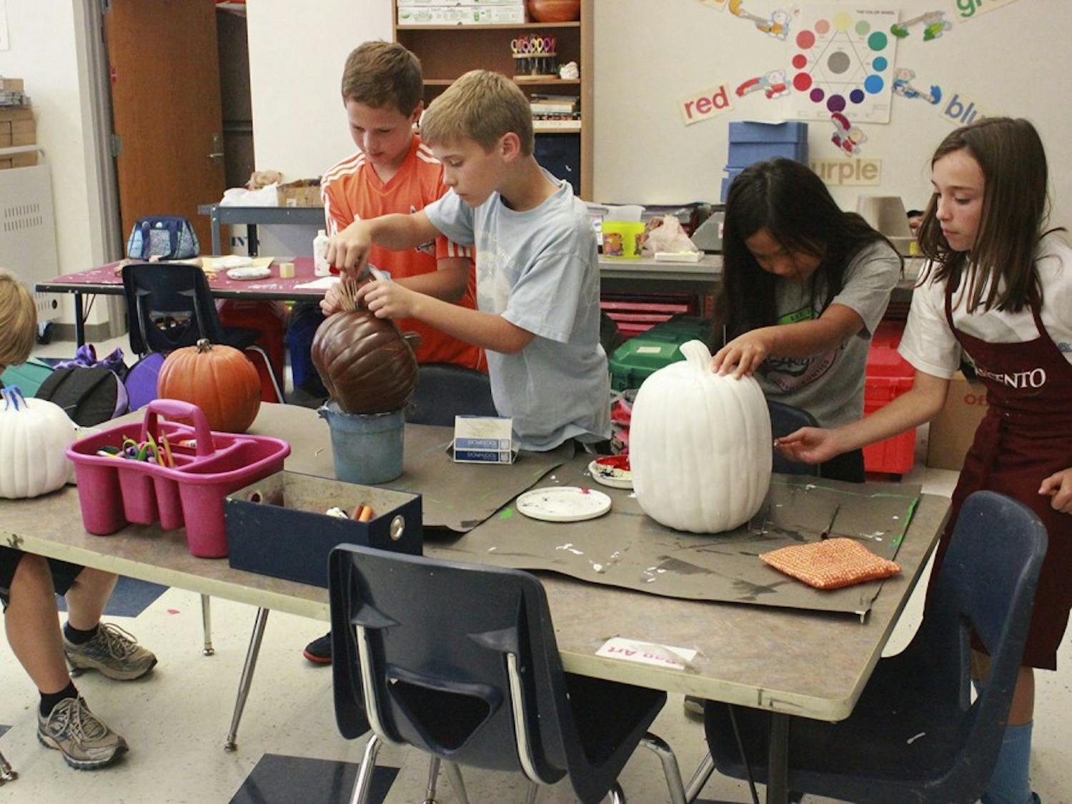 5th grade Art Club students at Morris Grove Elementary painted pumpkins on Tuesday after school for a pumpkin sale that will raise money for United Way. Art Club teacher, Mrs. Becky Springer, said the inspiration for the fundraiser came because "I'm just always looking for a creative outlet for the students...and then it just happened to coincide with United Way."