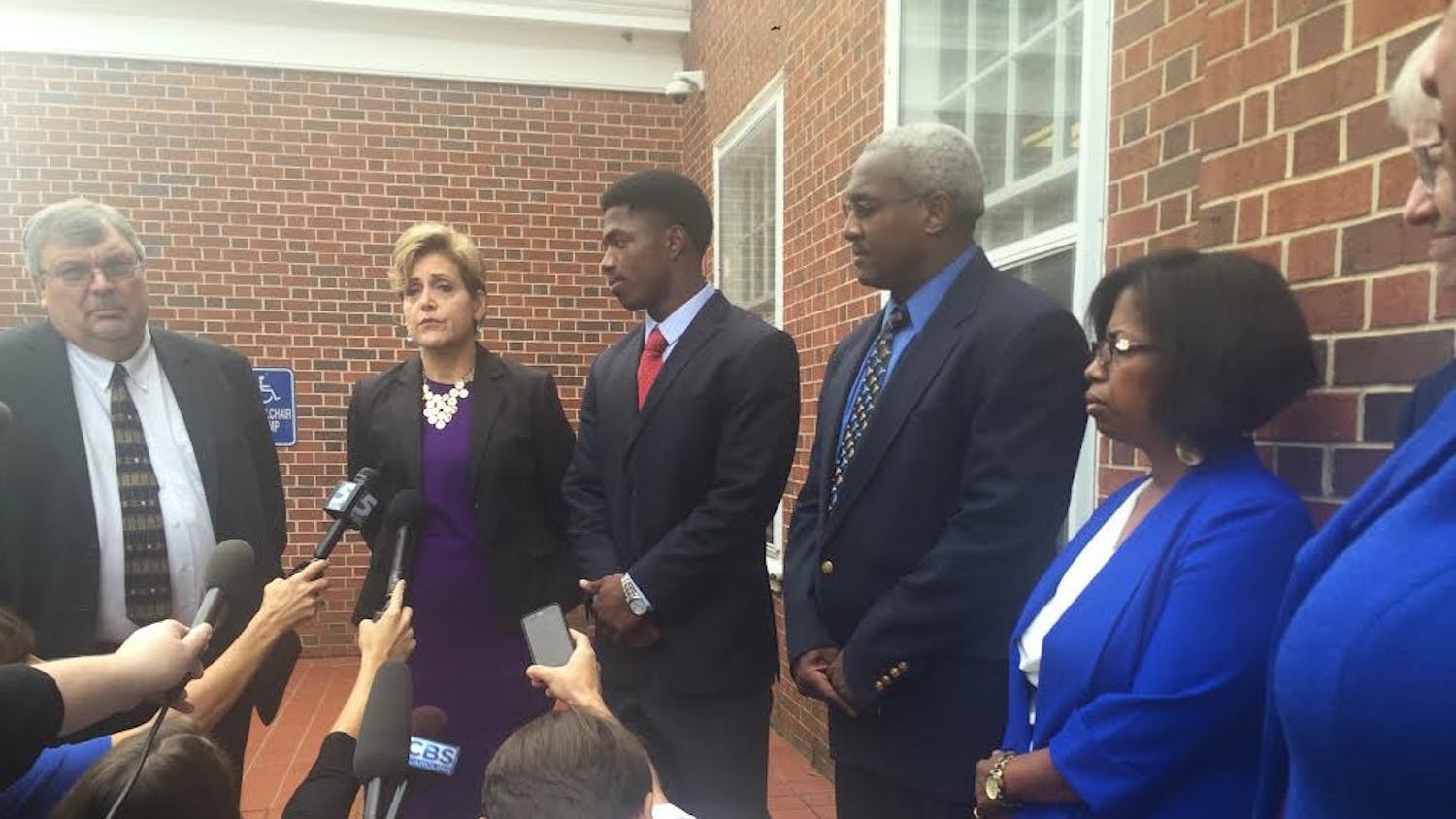 Allen Artis, surrounded by his lawyer and parents, speaks to the media after his court appearance.&nbsp;