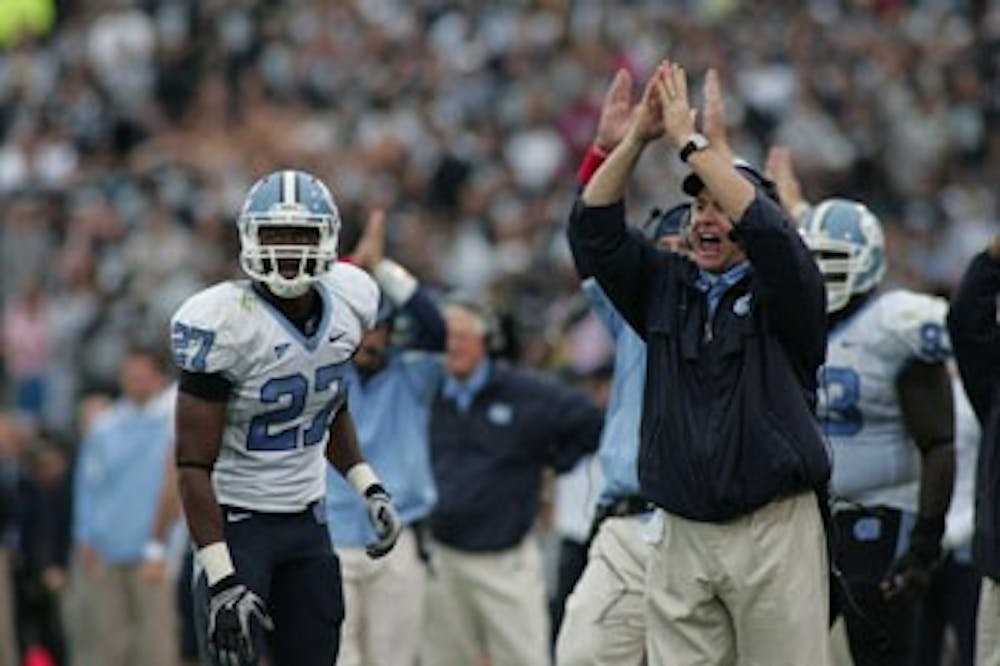 UNC safety Deunta Williams and head coach Butch Davis react to the game-winning safety.
