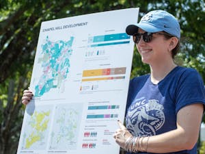 Julia Taylor, urban designer for Neighboring Concepts, tables in the Pit to raise awareness for Chapel Hill Transit's "Shaping Our Future" development initiative on Sept. 15, 2022.