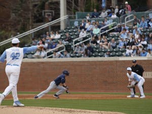 Junior pitcher Gianluca Dalatri (42) throws the ball to first-year first baseman Aaron Sabato (19) during UNC's 12-3 win against Xavier on Friday, Feb. 15, 2019.