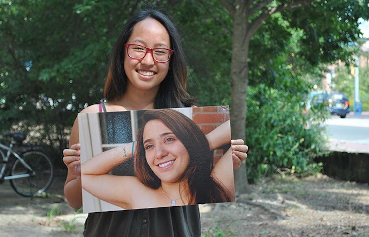 	Sheena Ozaki, Project Dinah chair, holds a photo of Andrea Pino outside the Union. Pino created the Courage Project, a display in the Union basement that includes pictures and stories from those who have been affected by sexual and interpersonal violence.