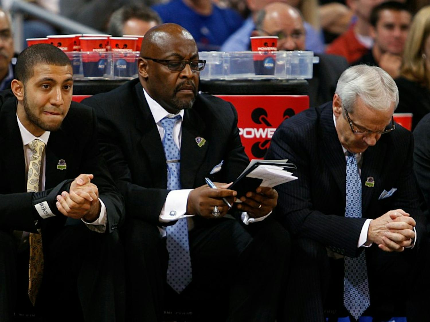 UNC guard Kendall Marshall, assistant coach Steve Robinson and head coach Roy Williams watch nervously from the bench as time winds down. The Tar Heels defeated Ohio 73-65 in overtime at the Edward Jones Dome in St. Louis on Friday in the Sweet 16 round of the NCAA Tournament.