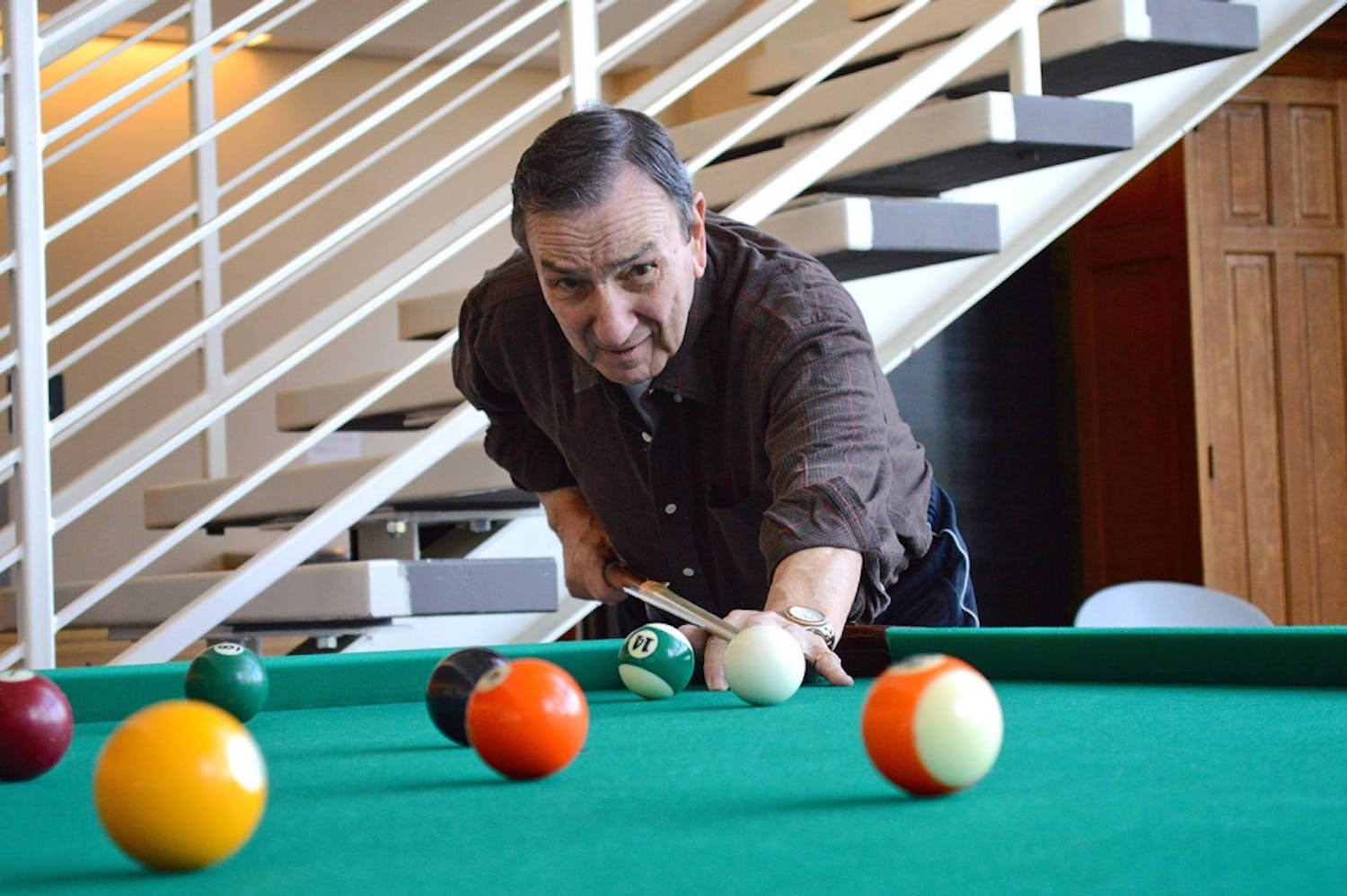 Orange County senior Joe Acciarito shoots pool at the Robert and Pearl Seymour Center in Chapel Hill, which he visits six times a week.