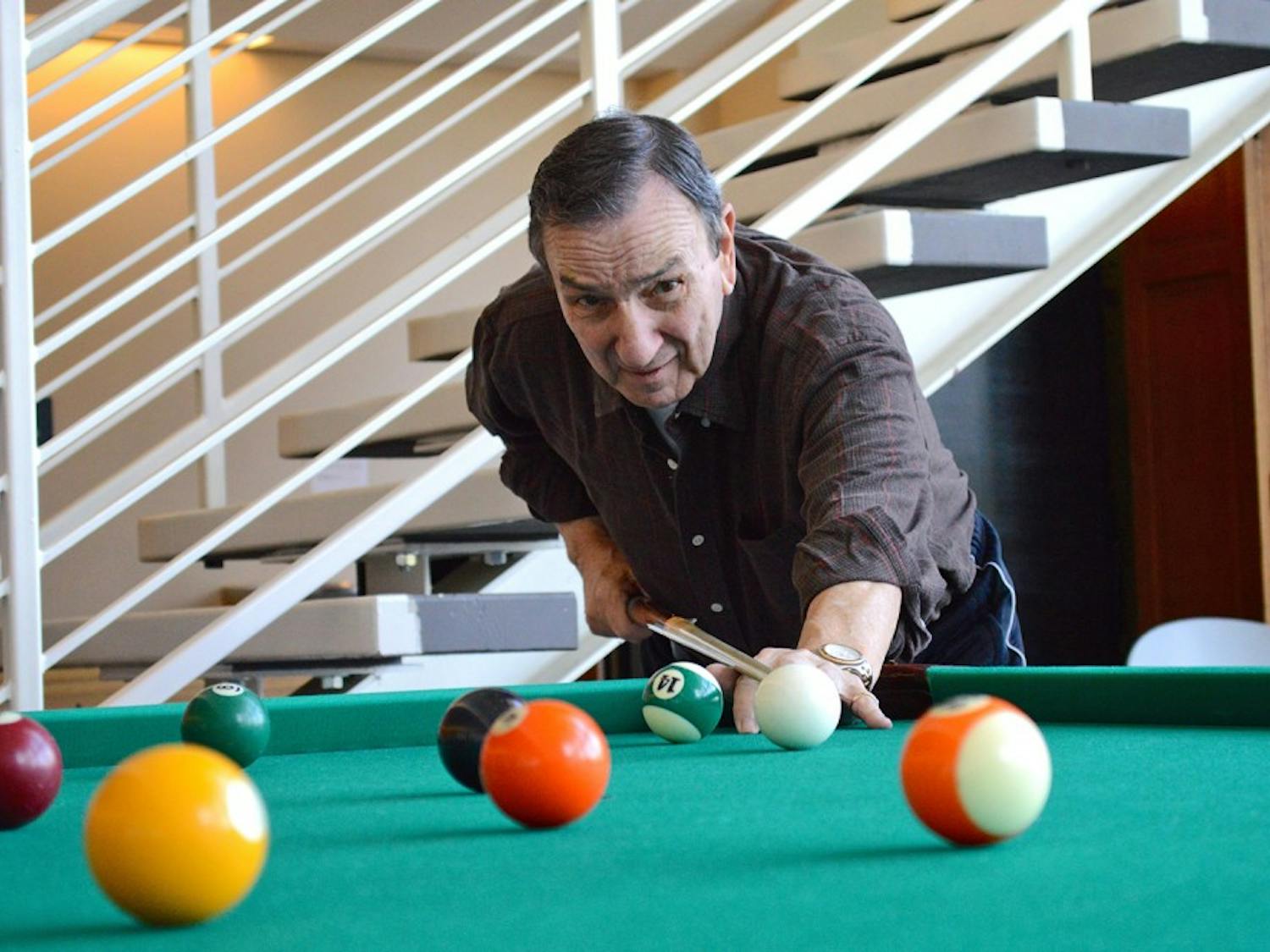 Orange County senior Joe Acciarito shoots pool at the Robert and Pearl Seymour Center in Chapel Hill, which he visits six times a week.