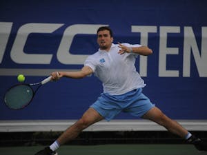 Junior William Blumberg swings at the ball at the ACC tournament semifinals. UNC played against Virginia and lost 3-4. Blumberg won his doubles match with senior Blaine Boyden and lost his singles match.