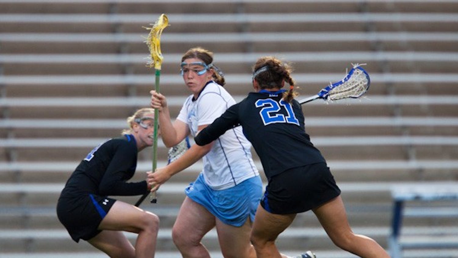 Junior Corey Donohoe works her way past two Duke defenders on her way to the goal Wednesday. DTH/Phong Dinh