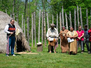 Jason Evans, a member of the Haliwa Saponi Tribe, performs music as Occaneechi tribal members listen at the Occaneechi Replica Village rededication event on Saturday, April 23, 2022.