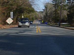 Cars drive down the busy Ephesus Church Road in Chapel Hill, NC on Tuesday, Feb. 15, 2022. The Town of Chapel Hill has proposed bike lanes that would result in narrower vehicle lanes and the prohibition of roadside parking.