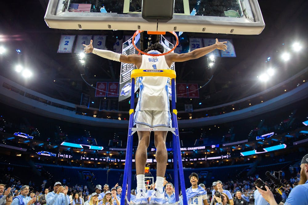 <p>Senior forward Leaky Black (1) climbs the ladder after winning the Elite 8 game against St. Peter's at the Wells Fargo Center in Philadelphia on March 27, 2022. UNC is advancing to the Final Four.&nbsp;</p>