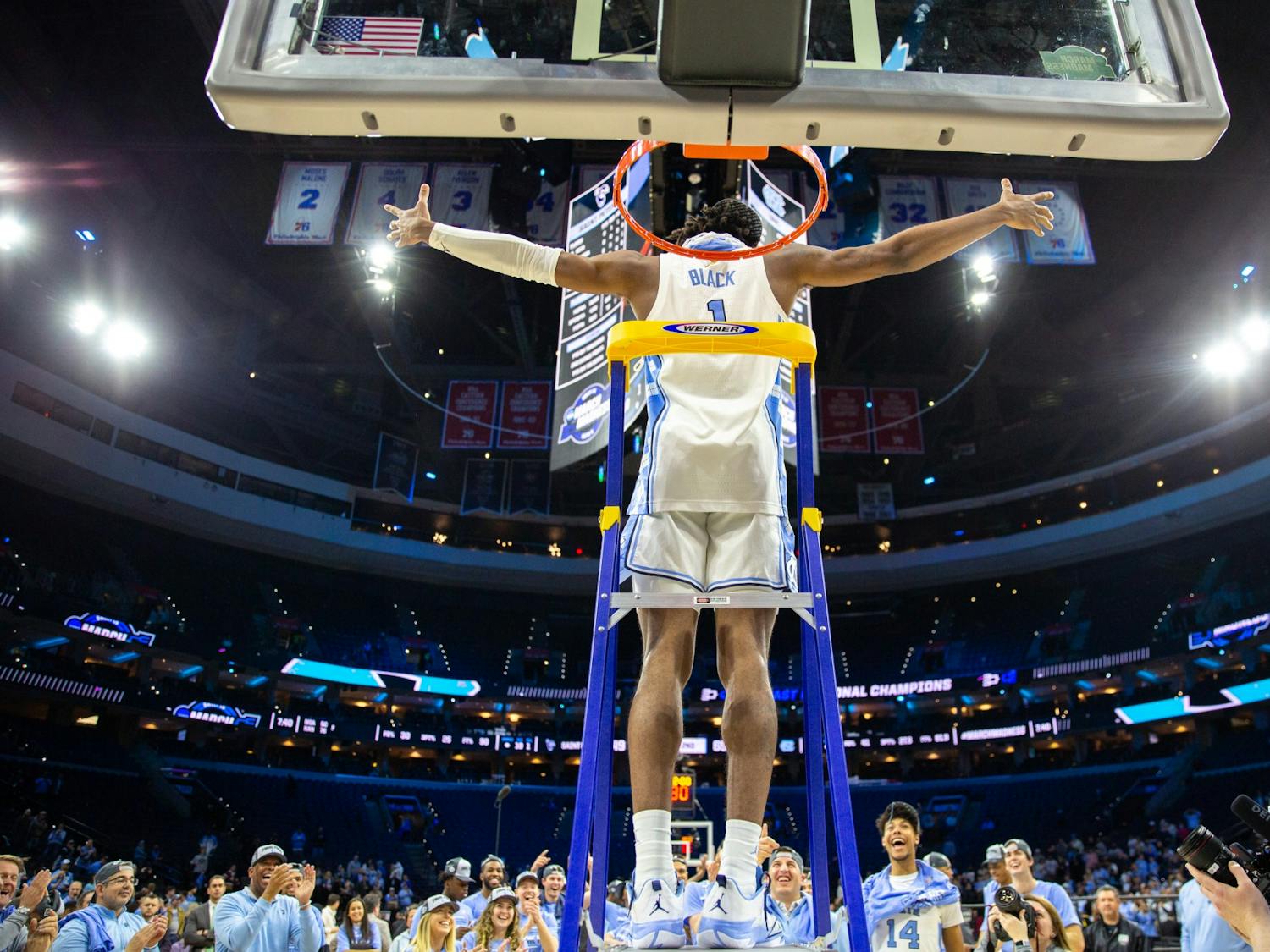 Senior forward Leaky Black (1) climbs the ladder after winning the Elite 8 game against St. Peter's at the Wells Fargo Center in Philadelphia on March 27, 2022. UNC is advancing to the Final Four.&nbsp;